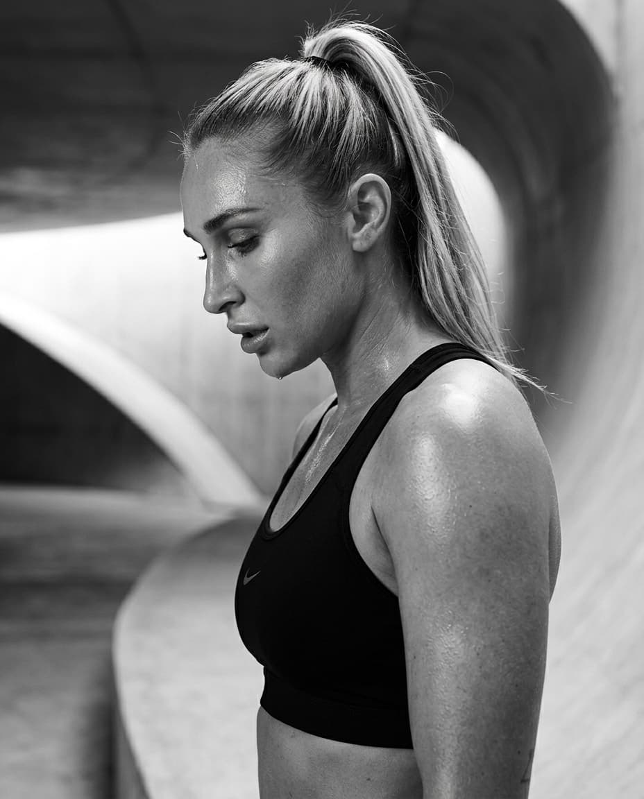 Black and white profile of Summer Loffler in a sculptural training space.